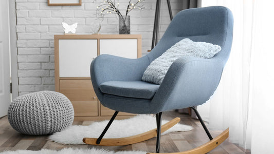 Modern nursing chair in a nursery room with soft cushion and wooden rocking base