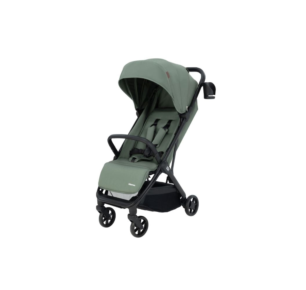 A compact stroller in sage green fabric with a black frame and wheels, shown from a three-quarters angle on a solid white background.