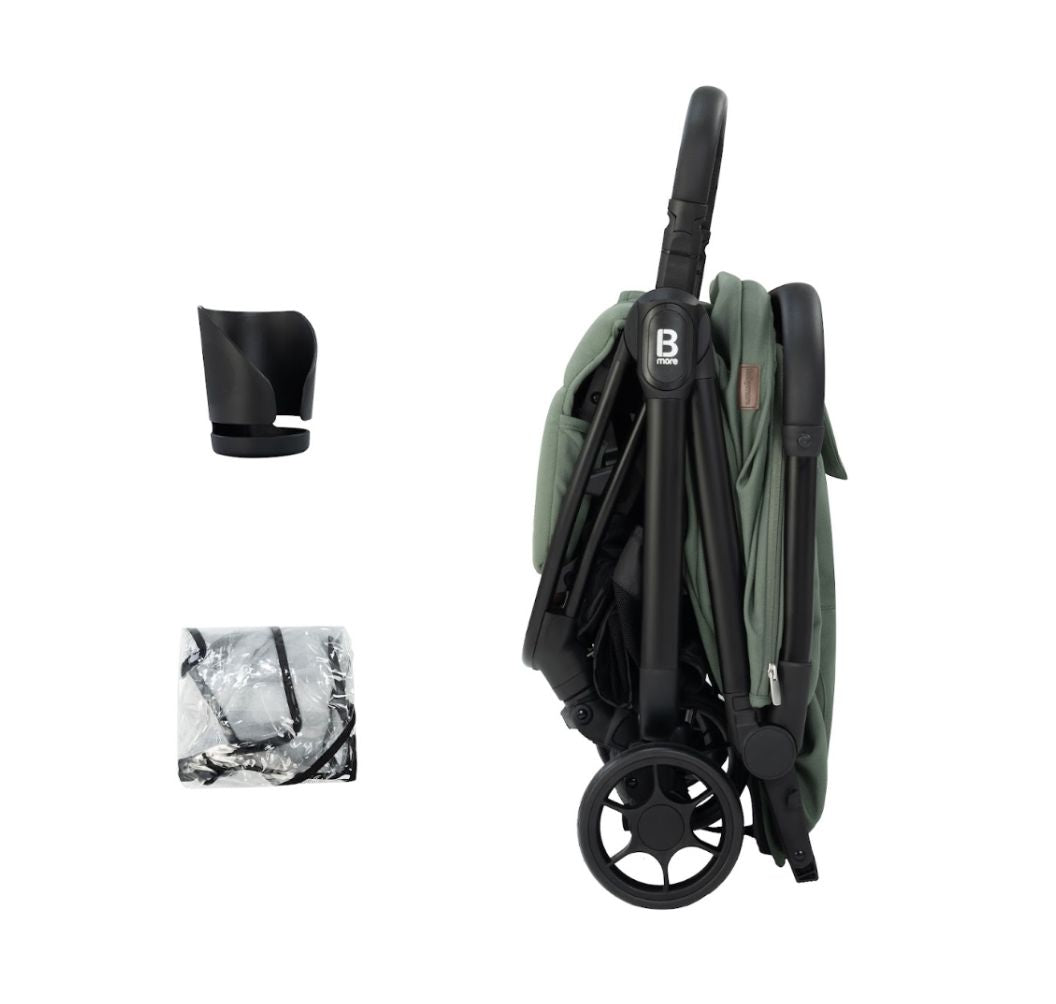 A compact stroller in sage green fabric with a black frame and wheels, shown from a three-quarters angle on a solid white background.