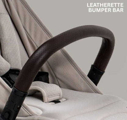 A compact stroller with a light beige canopy and seat, handlebars, and a black frame, shown on a neutral gray background with text at the top reading 'SUITABLE FROM BIRTH TO APPROX. 22KG'.