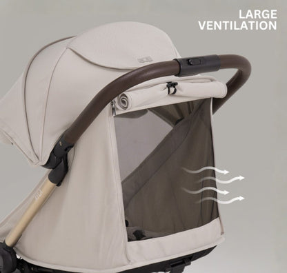 A compact stroller with a light beige canopy and seat, handlebars, and a black frame, shown on a neutral gray background with text at the top reading 'SUITABLE FROM BIRTH TO APPROX. 22KG'.